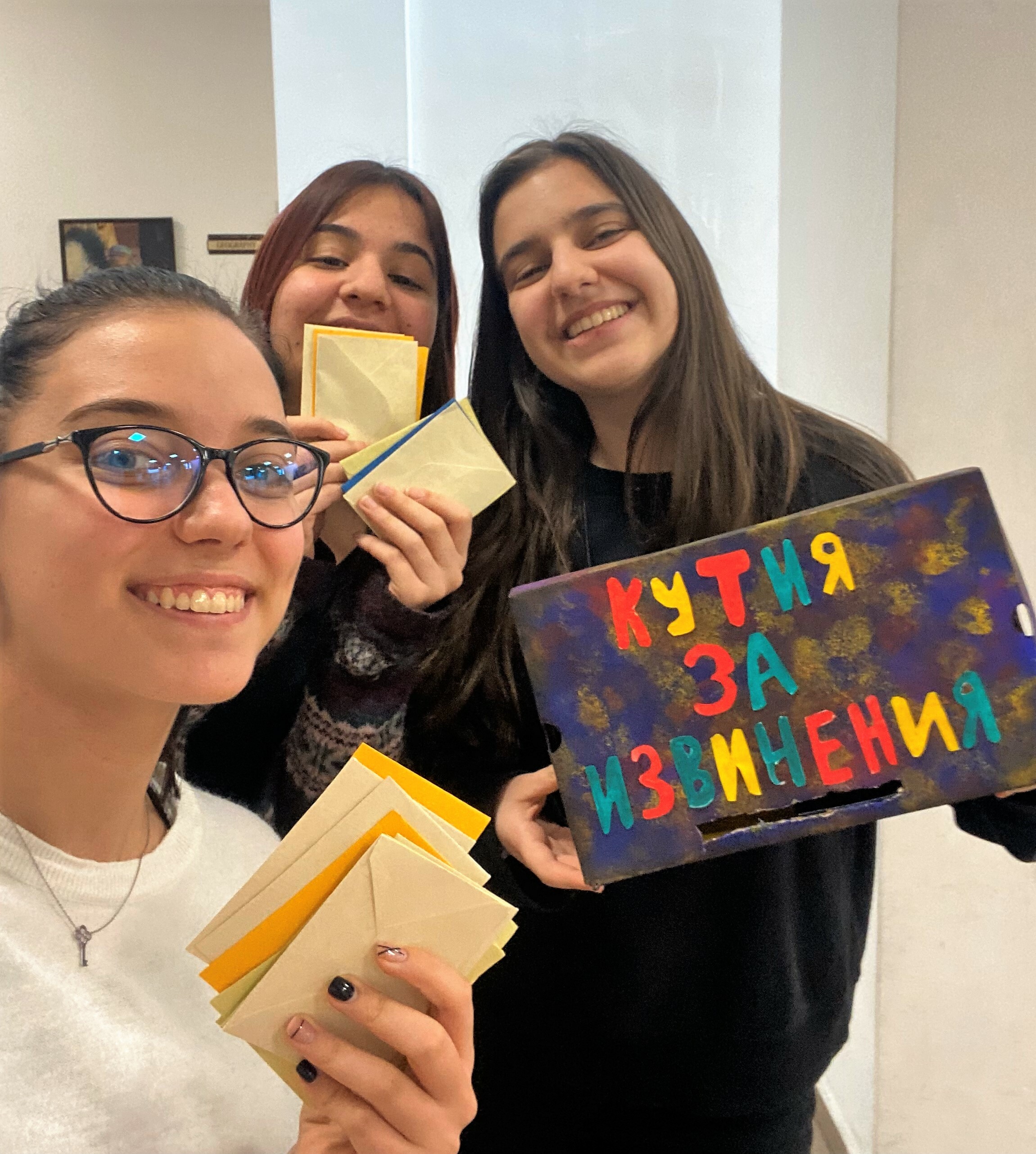 Three Alumnae From Bulgaria Hold Up A Box For Collecting Letters