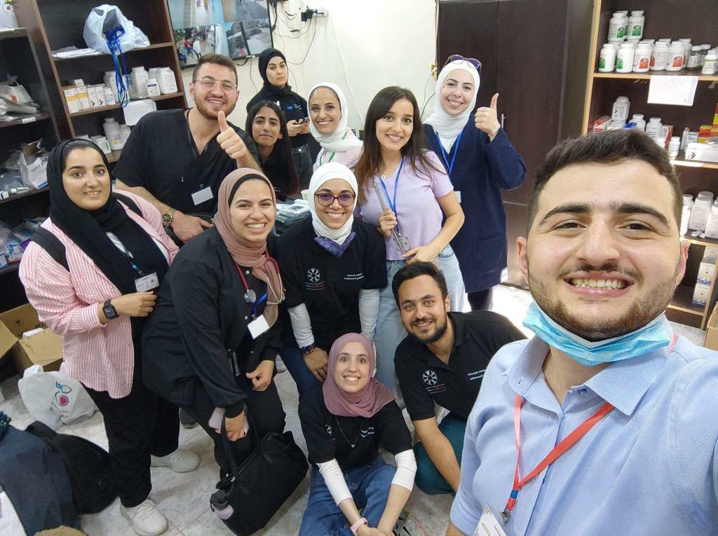 Twelve People Pose For A Group Photo At A Doctors For Peace Event In Jordan