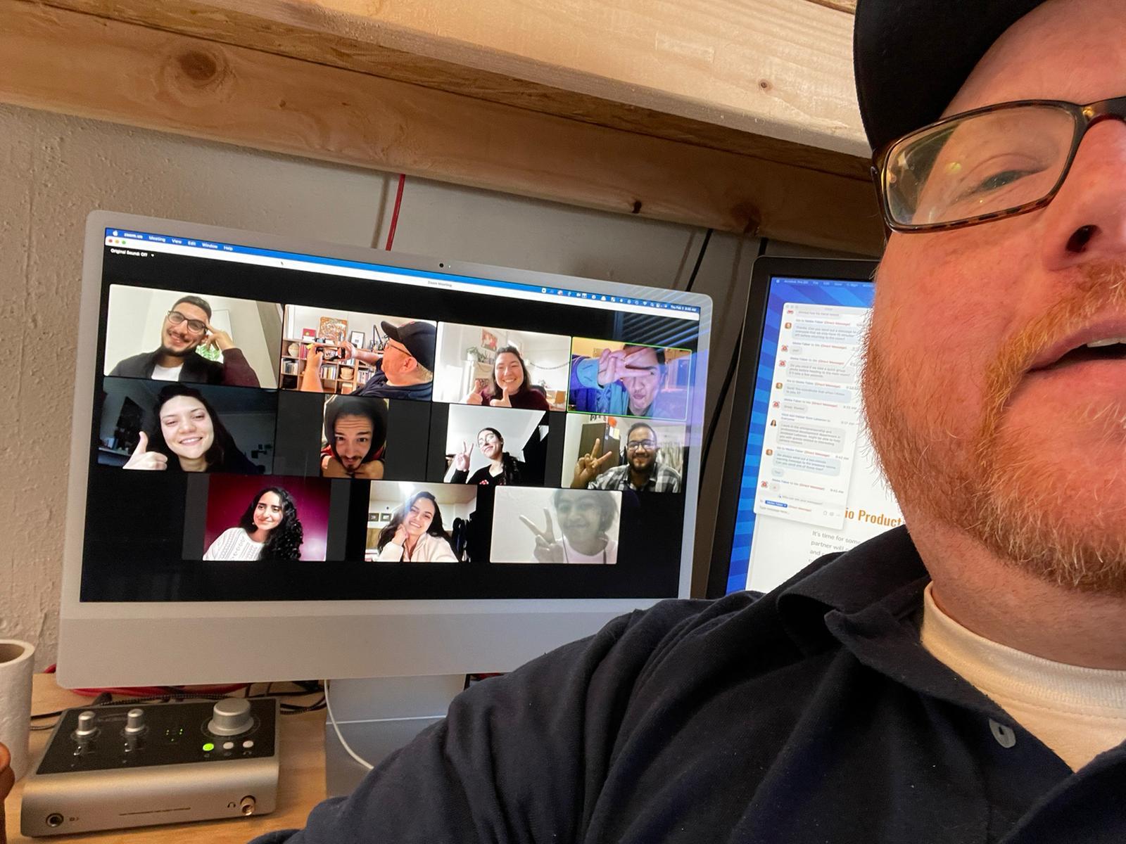 Podcast workshop trainer taking selfie with Zoom screen with podcast workshop participants