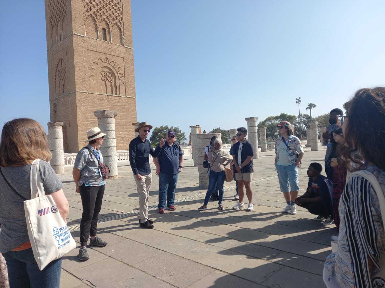 Workshop participants standing in a circle in front of the Hassan Tower