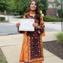 YES Alumna Tilyan holding her certificate from the Global Village program.  Jpeg 1