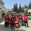Group of alumni and children in red t-shirts