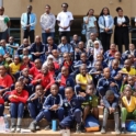 A group photo of participants and facilitators from day one of the Nairobi Eco Youth training at USIU Africa The diverse group of students and adults is seated on steps and smiling