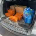 Trunk of a car filled with boxes and bags