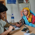 A medical student takes the blood pressure of a patient. 