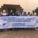Alumni hold a banner that advertising their project in French