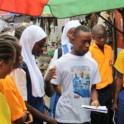 A Participant Is Talking To Shoppers At The Marketer About Ways They Can Reduce The Waste They Generate During Their Day To Day Activities