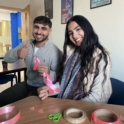 A young man and woman holding pink breast cancer awareness ribbons