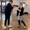 Ahmad handing a trophy to a woman