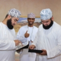 Three men use tablets