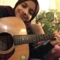 Alaa Playing The Guitar