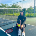 Alae sitting on a tennis court