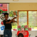 Alumna In South Africa Is Holding Up A Sanitary Pad Talking To A Group Of Young Women About Female Hygiene