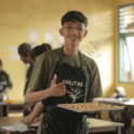 Ari holds a tray of his peanut butter cookies that are about to be baked. 