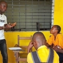 YES Liberia alumni activity teaching in a classroom. Classroom is bright yellow.