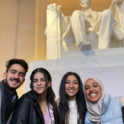 Four students pose in front of the Lincoln memorial statue