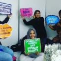 Five people hold signs about disabilities awareness