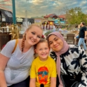 Fatimah with her host family at an amusement park. 