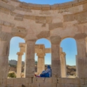 Fatma sitting in a open window of a historic archaeological site