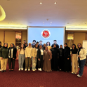 Group of alumni with the YES logo in the background
