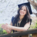 Hala in a black dress and graduation cap