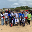 Participants smiling in a group picture on the beach