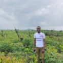 Allieu stands in a YES t-shirt in a field