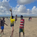 Group of children playing soccer on the beach. 