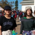 Hina with a friend, holding a trash back at the coastal clean up event.