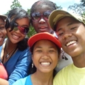 Five people smile together for a selfie