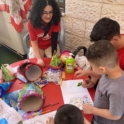 Alumni drawing at a table with children
