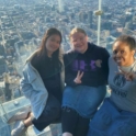 Audrey and her host sisters at a window overlooking the Chicago skyline