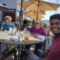 Sai and host family at outdoor restaurant