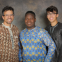 YES student, Jimmy, standing in between his host dad and host brother in traditional Nigerian clothing.