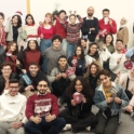 Large group of alumni holding holiday motifs