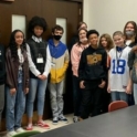 A group of young students gathers for a photograph in a classroom