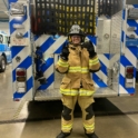 Mohammad Wearing A Firefighter Uniform In Front Of A Fire Truck