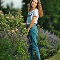 Myriam Dhouibi stands next to pink and purple flowers