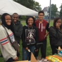 Naima and four other students stand behind a concession stand laughing