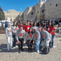 Group of YES alumni in gray sweatshirts with the YES logo