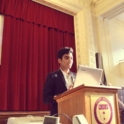 Osaid giving presentation behind podium