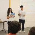 A young man and woman holding flyers