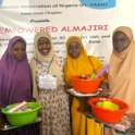 Project leader Fatma and three students pose together holding mixing bowls