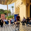 Project Leader Luqman Bakeer Is Speaking To A Group Seated In A Circle