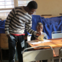 An alum reads with a youth