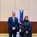 Reem in a navy abaya with an older man in a navy suit