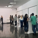 Students gather around tables at an orientation