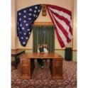 YES student sitting at a governor's desk in the DC capitol. U.S. flag is hanging above her.