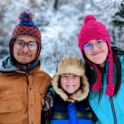 YES student, Sadman, standing in the snow with his two host siblings