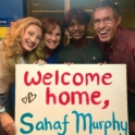 Sahaf meets his host family and they hold a welcome sign